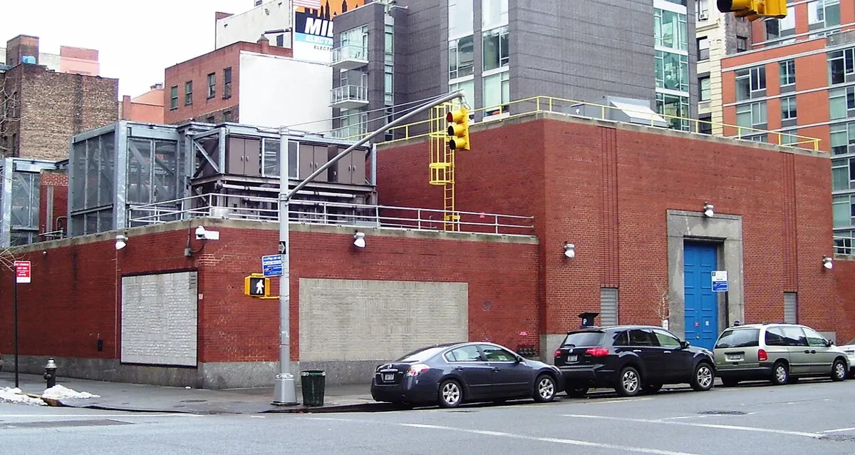 Red brick electrical substation with cooling equipment on a Manhattan street corner